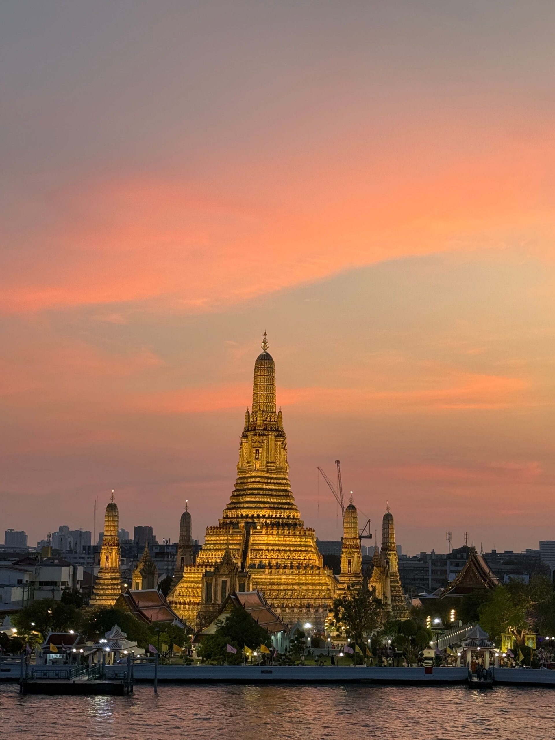 Magnificent view of Wat Arun Temple during a vibrant sunset in Bangkok, Thailand.